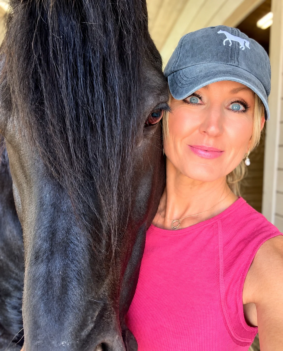Carol Whitaker cheek to cheek with her black Friesian stallion, Dante