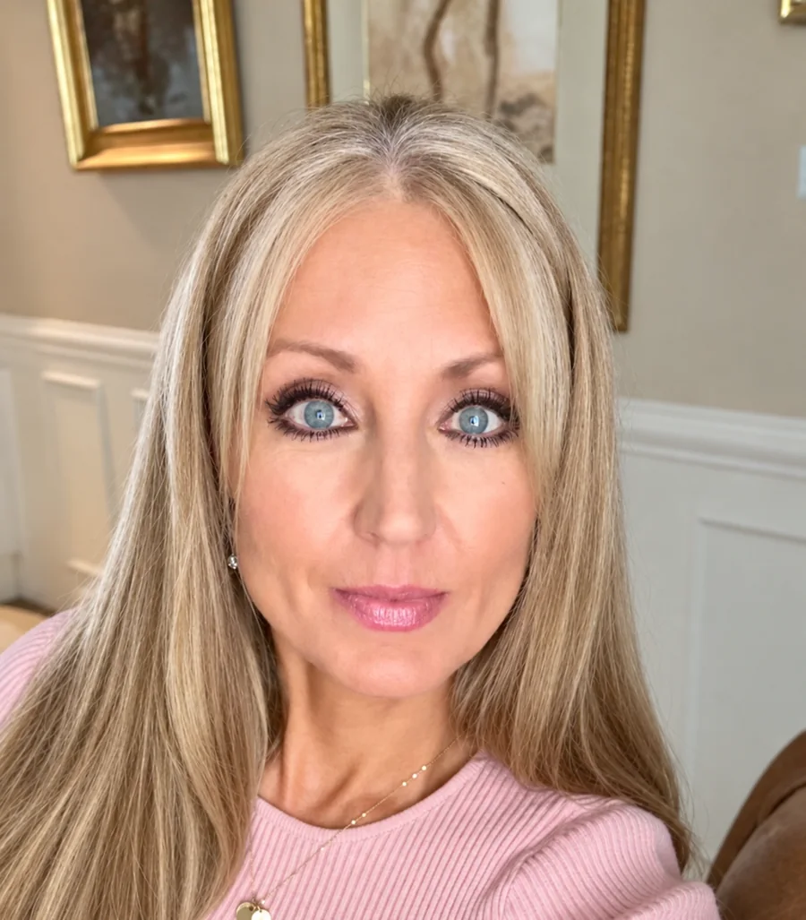 Carol Whitaker, life coach for women, in a soft pink sweater