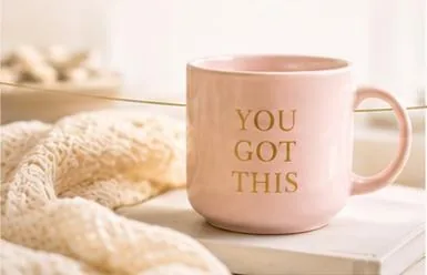 Pink mug reading You got this beside a soft knit blanket